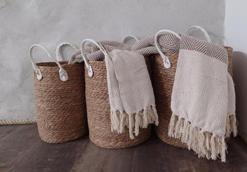 three woven baskets sitting on a wooden floor at Mas de la Borie -Chambre d'hôtes in Joannas