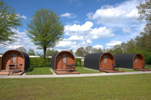 a group of three circular tents in a park at Campingpod in Südbrookmerland