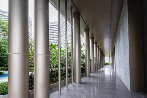 an empty hallway of a building with columns at Puhai Sea View Apt by Hailan Tour at Sanya Yazhou Bay#only 100 meters to Beach and Sea Swimming Area in Sanya