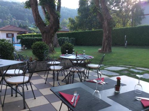 a group of tables and chairs on a patio at Hotel La Torre in Castiglione dʼIntelvi