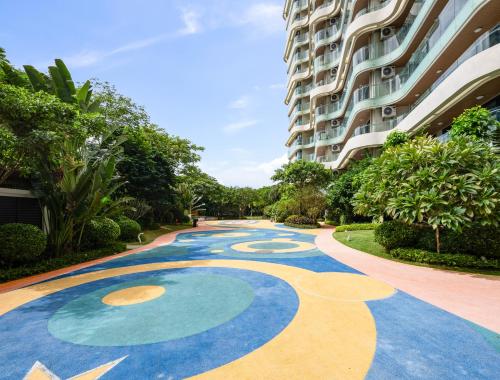 a painting on the ground in front of a building at Puhai Sea View Apt by Hailan Tour at Sanya Yazhou Bay#only 100 meters to Beach and Sea Swimming Area in Sanya