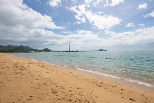 a sandy beach with a view of the ocean at Puhai Sea View Apt by Hailan Tour at Sanya Yazhou Bay#only 100 meters to Beach and Sea Swimming Area in Sanya