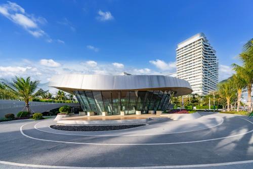 a building in the middle of a street with a building at Puhai Sea View Apt by Hailan Tour at Sanya Yazhou Bay#only 100 meters to Beach and Sea Swimming Area in Sanya