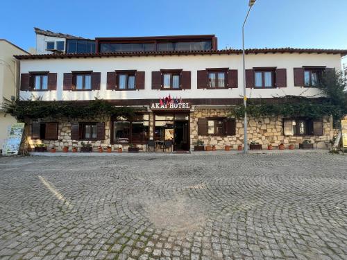 a building with a cobblestone street in front of it at Akay Hotel in Selcuk