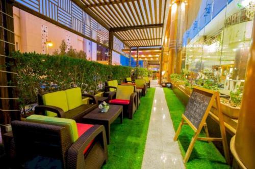 a row of chairs and tables in a building at Dancenter Luxury Millennia Near King Abdulaziz Historical Center in Riyadh