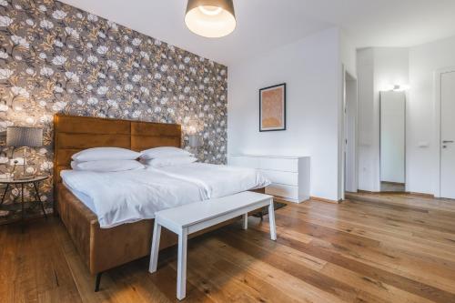 a bedroom with a large bed and a wooden floor at Apartment Vila Pavlovski in Bled