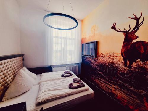 a bedroom with a painting of a deer on the wall at Jägerhof Putzkau in Putzkau