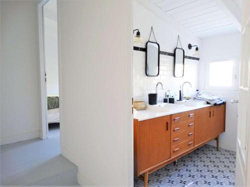 a bathroom with a sink and a mirror at Palme - Saint Gilles Croix de Vie in Saint-Gilles-Croix-de-Vie
