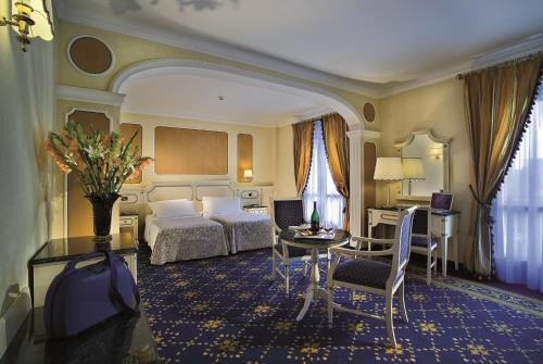 מיטה או מיטות בחדר ב-Palace Hotel Meggiorato