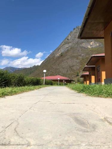 a building with a mountain in the background at Risum Resort in Ha
