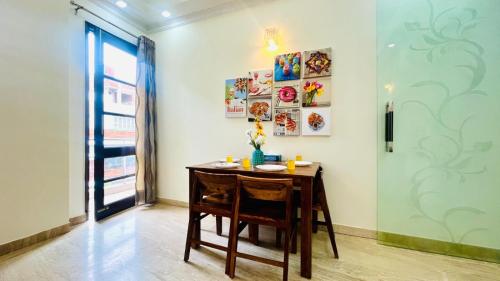 a dining room with a table and a window at Olive Service Apartments - Green Park in New Delhi