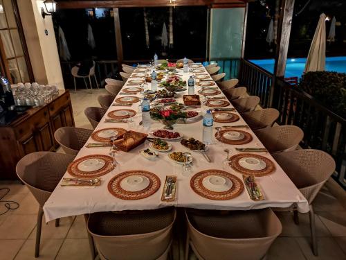 a long table with plates of food on it at Efe Hotel Gocek in Göcek