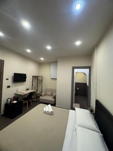 a bedroom with a bed and a living room at Sistra in Catania