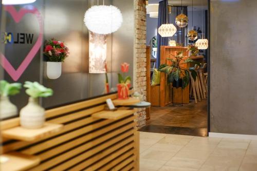 a lobby with a flower shop with potted plants at The Townhouse Ruhpolding - Individual Design & Casual Concept in Ruhpolding