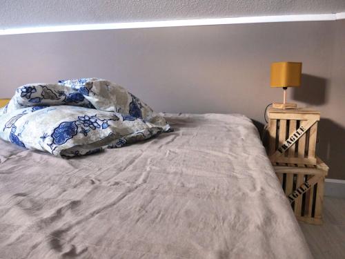 a bed with two pillows and a lamp on it at Mas de la Borie -Chambre d'hôtes in Joannas