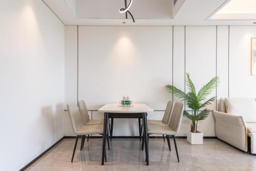 a dining room with a table and chairs at Puhai Sea View Apt by Hailan Tour at Sanya Yazhou Bay#only 100 meters to Beach and Sea Swimming Area in Sanya