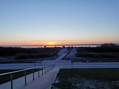 a road leading to the beach at sunset at Pension Sonnenstrand in Norden