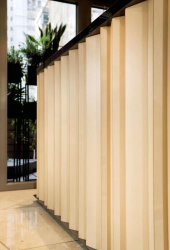 a striped wall in front of a building at The OTTO Hotel in Hong Kong