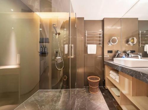 a bathroom with a shower and a sink at Elegant International Hotel Shanghai - Bund Sichuan Road North Metro Station Branch in Shanghai