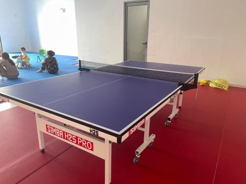 a ping pong table in a room with two children at HN ETH Vinhomes D'capitale Resident - Tran Duy Hung St in Hanoi