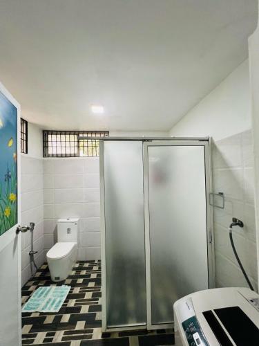 a bathroom with a shower and a toilet at Nima villa in Tangalle
