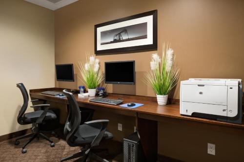 an office with a desk with two computers and two chairs at Microtel Inn & Suites by Wyndham Lloydminster in Lloydminster