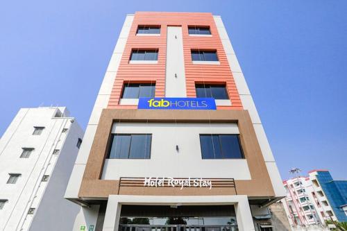 a tall building with a blue sign on it at FabHotel Royal Stay - Beltarodi in Nagpur