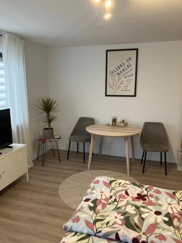 a room with a bed and a table and chairs at Apartment Anna in Inzigkofen
