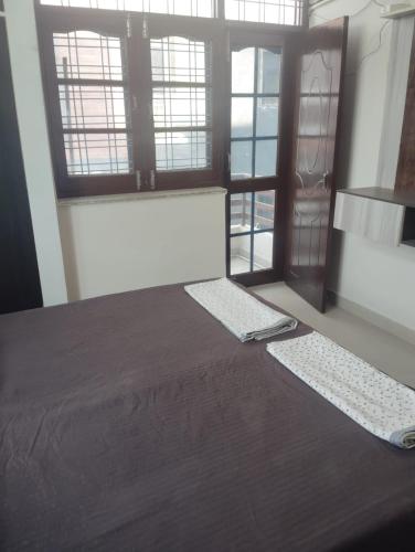 a bedroom with a bed and two keyboards on the floor at Yog kul Home Stay - Premium in Rishīkesh