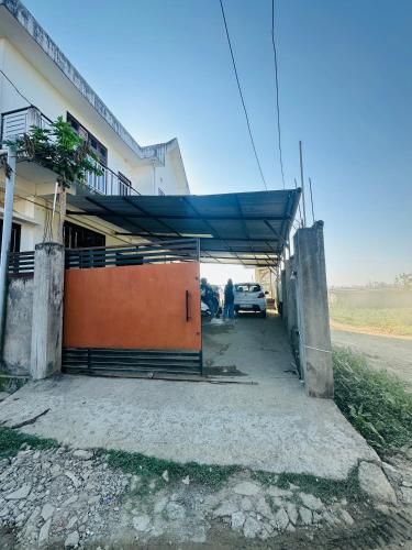 a garage with a car parked inside of it at Ranghar Homestay Sivasagar in Sivasagar