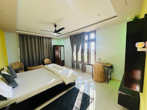 a bedroom with a large bed and a window at Ranghar Homestay Sivasagar in Sivasagar