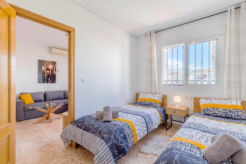 a bedroom with two beds and a mirror at Azalea - Stylish Apartment with Rooftop & Pool in Los Altos