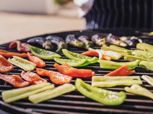 a bunch of vegetables cooking on a grill at Grecotel Creta Palace in Rethymno Town