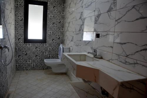 a bathroom with a sink and a toilet at JASMIN MWT MUNICH ---800 Meter zum Strand-Sea-Beach in Djerba