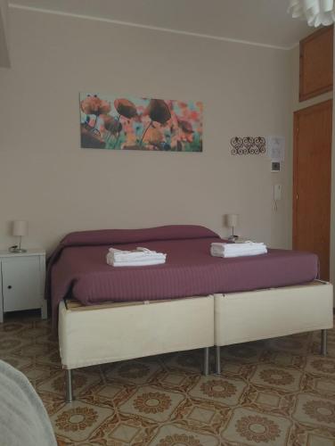 a bedroom with a bed with a purple mattress at MONOLOCALI DA VINCI in Falconara Marittima
