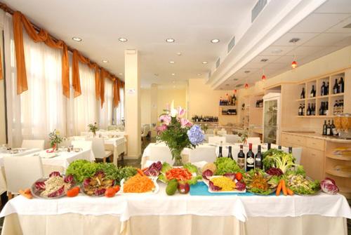 a table with vegetables on it in a restaurant at Hotel Europa in San Bartolomeo al Mare