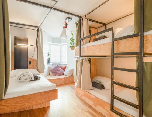 a bedroom with two bunk beds and a ladder at Montagu Hostel in Innsbruck