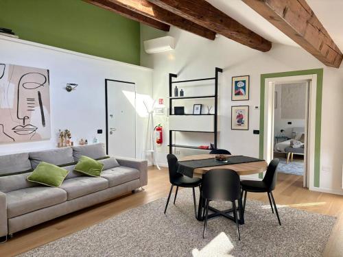 a living room with a couch and a table at The New Place in Ferrara