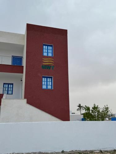 a red building with a nyu sign on it at JASMIN MWT MUNICH ---800 Meter zum Strand-Sea-Beach in Djerba