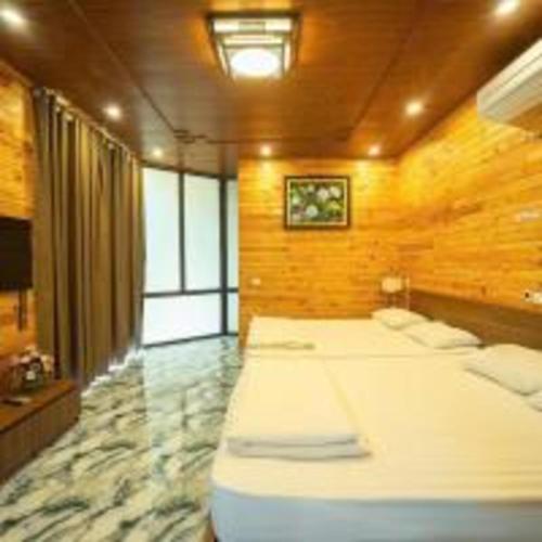 a bedroom with two beds in a room at SH Homestay - Venuestay in Sóc Sơn