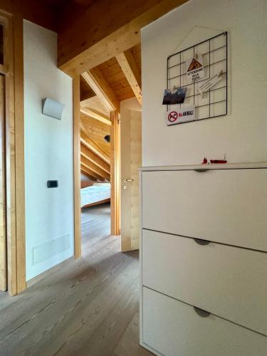 a room with a chest of drawers and a hallway at Mansarda da Nonna Berbelina in Belluno