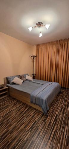a bedroom with a large bed in a room at РЕЛАКС - апартамент 1 in Chepelare