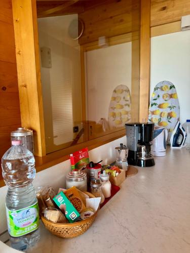a kitchen counter with a basket of food and a bottle of water at Mansarda da Nonna Berbelina in Belluno