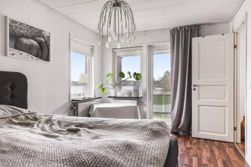 a bedroom with a bed and a desk and a window at Ronneby Torneryd Retreat in Ronneby