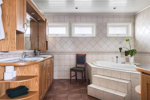 a bathroom with a sink and a bath tub at Ronneby Torneryd Retreat in Ronneby