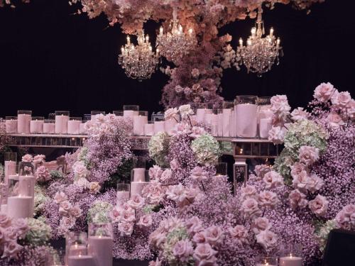 a wedding reception with pink flowers and chandeliers at The William Inglis Mgallery in Warwick Farm
