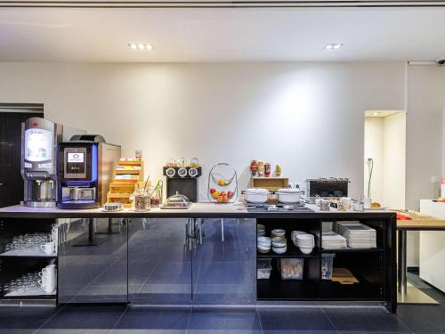 a kitchen with a counter with a microwave at Adagio Nice Centre in Nice