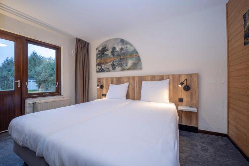 Postel nebo postele na pokoji v ubytování Fletcher Hotel-Restaurant de Witte Brug