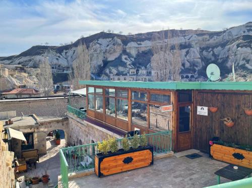 a balcony of a building with mountains in the background at Gedik Cave Hotel in Goreme