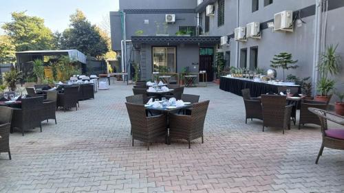 an outdoor patio with tables and chairs and a restaurant at Burj Ul Zaki in Islamabad